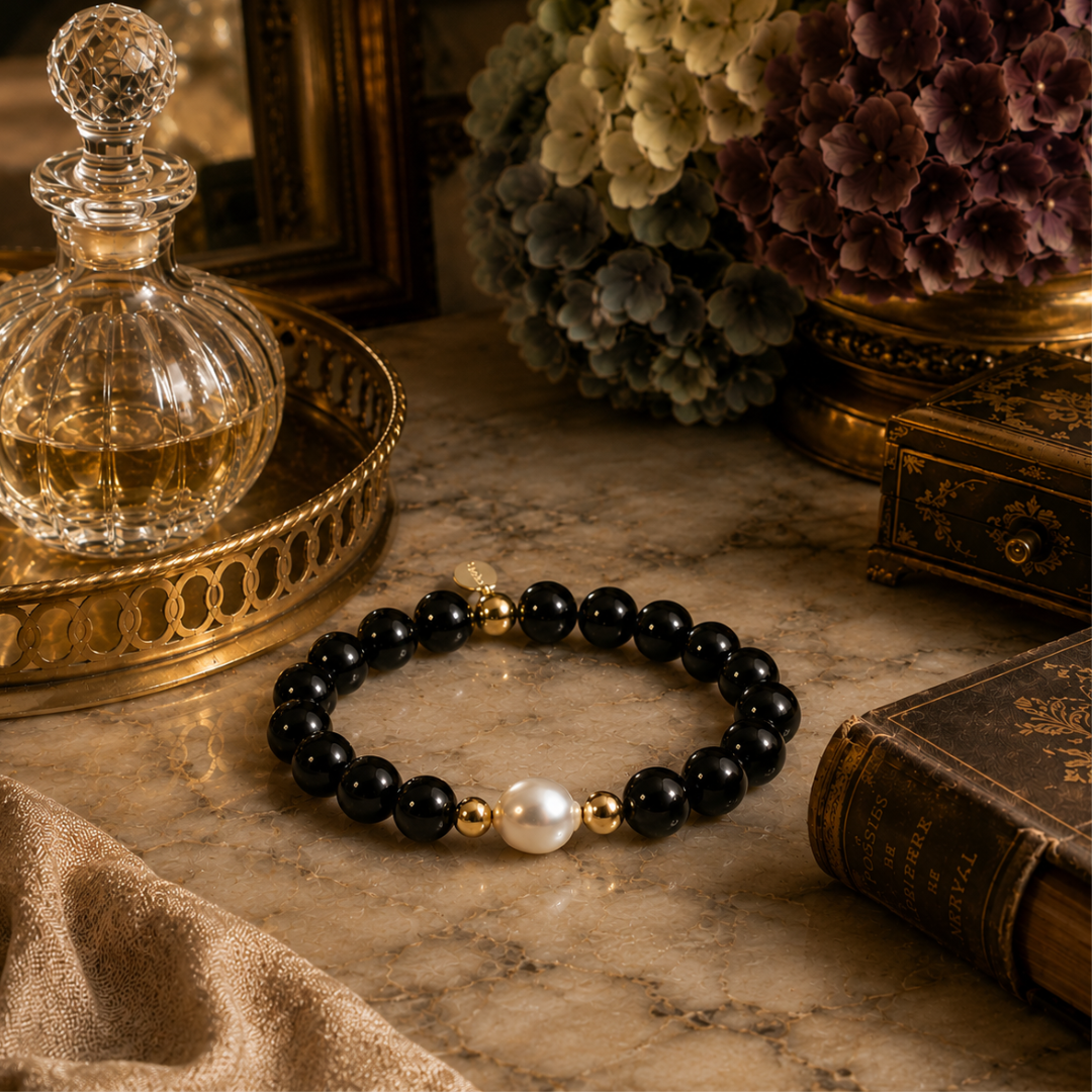 Black Onyx Bracelet beaded bracelet with a pearl on a marble surface with decorative items. Teramasu Confidence Collection