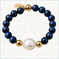 Blue Tiger's Eye and baroque pearl luxury handmade bracelet with 14K gold-filled beads and Teramasu signature tag on a light linen background.