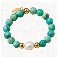 Turquoise and baroque pearl luxury handmade bracelet with 14K gold-filled beads and Teramasu signature tag on a light linen background.