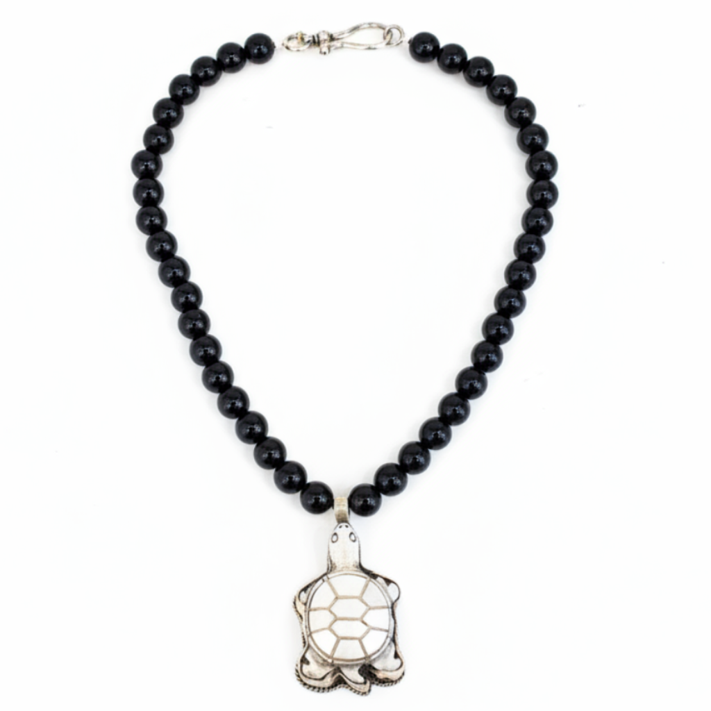 Teramasu black onyx beaded necklace with a silver turtle pendant on a white background