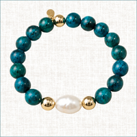 Luxury handmade Chrysocolla and baroque pearl bracelet with gold-filled accents by Teramasu on a light linen background.
