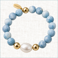 Luxury Larimar gemstone bracelet with baroque pearl, gold filled beads, and Teramasu signature tag on a soft linen background.