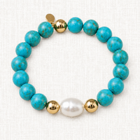 Luxury handmade turquoise and baroque pearl bracelet with gold-filled accents by Teramasu on a light linen background.