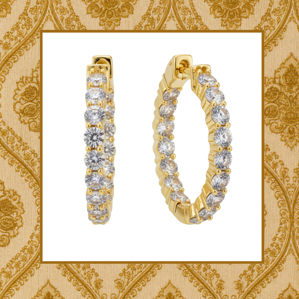 Signature Travel Hoop Earrings on a luxury gold patterned background